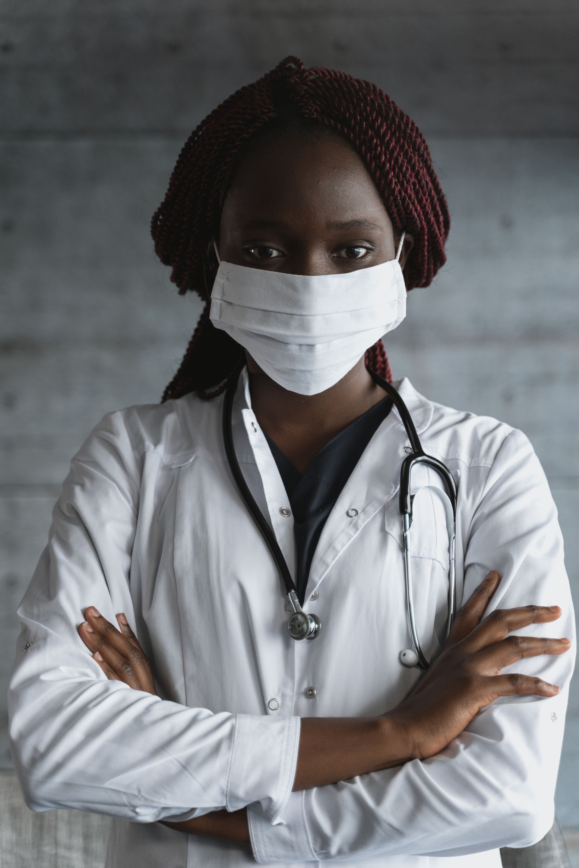 Physician in mask and white coat
